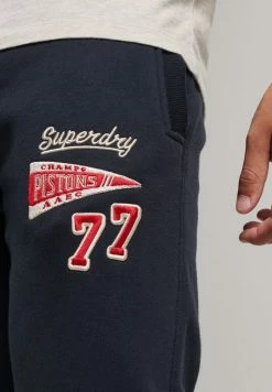 Superdry COLLEGIATE - Tracksuit Bottoms - Eclipse Navy -Superdry Shop 628d47cbce61410480b526ba9fbeee7e